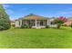A beautiful grassy backyard and screened lanai perfect for entertaining or relaxing at 9588 Se 124Th Loop, Summerfield, FL 34491