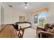 Bedroom featuring a daybed, chair, window and carpet flooring at 9588 Se 124Th Loop, Summerfield, FL 34491