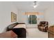 Bright bedroom featuring a daybed, chair, window and carpet flooring at 9588 Se 124Th Loop, Summerfield, FL 34491