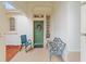 Cozy front porch with seating, offering a welcoming entrance to the home at 9588 Se 124Th Loop, Summerfield, FL 34491