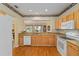 The kitchen features light wooden cabinets, granite countertops, and stainless steel appliances at 9588 Se 124Th Loop, Summerfield, FL 34491