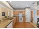 Bright eat-in kitchen featuring wood-style floors, granite countertops, and white appliances at 9588 Se 124Th Loop, Summerfield, FL 34491
