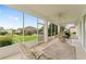 Comfortable lanai with ceiling fan and exterior views of the lush green lawn at 9588 Se 124Th Loop, Summerfield, FL 34491