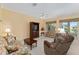 Spacious living room with neutral carpet, a ceiling fan, and natural light at 9588 Se 124Th Loop, Summerfield, FL 34491