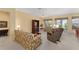 Comfortable living room featuring a ceiling fan, plush seating, and sliding glass doors at 9588 Se 124Th Loop, Summerfield, FL 34491