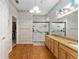 Main bathroom with granite counters, double sinks and a walk-in shower at 9588 Se 124Th Loop, Summerfield, FL 34491
