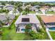 A well-maintained backyard features a screened pool and solar panels on the roof at 965 Dartmouth Ave, Clermont, FL 34711