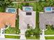 The aerial view showcases a private pool, solar panels, and a well-manicured lawn at 965 Dartmouth Ave, Clermont, FL 34711