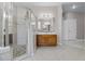 Modern bathroom featuring a glass-enclosed shower, single vanity, and tiled floor at 965 Dartmouth Ave, Clermont, FL 34711