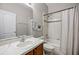 Bright bathroom features tub-shower, white marble vanity and coordinated finishes at 965 Dartmouth Ave, Clermont, FL 34711