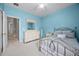 Well-lit bedroom featuring a large dresser and a view into the hallway at 965 Dartmouth Ave, Clermont, FL 34711