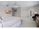 Spacious bedroom with a ceiling fan, view to backyard, and access to an ensuite bathroom at 965 Dartmouth Ave, Clermont, FL 34711