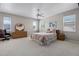 Cozy bedroom with ample natural light, ceiling fan, and comfortable furnishings at 965 Dartmouth Ave, Clermont, FL 34711