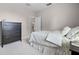 Bedroom with carpet, black dresser, and view to en-suite bathroom at 965 Dartmouth Ave, Clermont, FL 34711