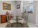 Breakfast nook with a glass top table and four upholstered chairs by window at 965 Dartmouth Ave, Clermont, FL 34711