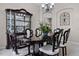 Charming dining room with a dark wood table and elegant display cabinet at 965 Dartmouth Ave, Clermont, FL 34711