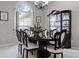 Formal dining room with elegant chandelier, display cabinet, and large window at 965 Dartmouth Ave, Clermont, FL 34711