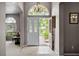 Grand foyer with arched window above front door and chandelier at 965 Dartmouth Ave, Clermont, FL 34711