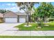 Charming home with a three car garage and landscaped front yard with beautiful trees at 965 Dartmouth Ave, Clermont, FL 34711