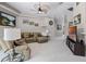 Cozy living room with comfortable seating, soft carpet and TV at 965 Dartmouth Ave, Clermont, FL 34711