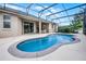 The large, screened in-ground pool is perfect for relaxing and entertaining at 965 Dartmouth Ave, Clermont, FL 34711