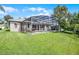 A beautiful screened-in pool is surrounded by a green yard, perfect for outdoor enjoyment at 965 Dartmouth Ave, Clermont, FL 34711