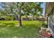 Well-maintained backyard with lush green grass and mature trees, offering a private outdoor space at 102 Lake Emma Cove Dr # 102, Lake Mary, FL 32746