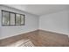 Bright bedroom featuring hardwood floors and large window with blinds, offering natural light at 102 Lake Emma Cove Dr # 102, Lake Mary, FL 32746