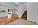 Bright foyer featuring wood and tile floors, a staircase, and a coat closet adjacent to the living area at 102 Lake Emma Cove Dr # 102, Lake Mary, FL 32746