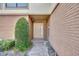Inviting front entrance with brick pathway and well maintained landscaping leading to a stylish door at 102 Lake Emma Cove Dr # 102, Lake Mary, FL 32746