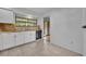 Bright kitchen featuring granite countertops, white cabinets, and tile floors at 102 Lake Emma Cove Dr # 102, Lake Mary, FL 32746