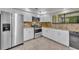 Modern kitchen featuring stainless steel appliances, granite countertops, tile flooring, and white cabinetry at 102 Lake Emma Cove Dr # 102, Lake Mary, FL 32746