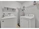 Practical laundry room equipped with washer, dryer and water heater, providing convenience at 102 Lake Emma Cove Dr # 102, Lake Mary, FL 32746