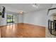 Cozy living room with wood floors, a fireplace, a ceiling fan, and access to the backyard via sliding glass doors at 102 Lake Emma Cove Dr # 102, Lake Mary, FL 32746