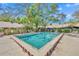 Community pool surrounded by mature trees and landscaping provides a relaxing outdoor space for residents and their guests at 102 Lake Emma Cove Dr # 102, Lake Mary, FL 32746