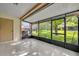 Screened porch with tiled floor, providing a relaxing outdoor space with view of the backyard at 102 Lake Emma Cove Dr # 102, Lake Mary, FL 32746