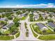 Aerial view of Sterling Pointe neighborhood with manicured lawns, tree-lined streets, and community entrance at 1034 Copenhagen Way, Winter Garden, FL 34787