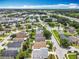 Overhead view of a neighborhood with mature trees, highways and commercial areas at 1034 Copenhagen Way, Winter Garden, FL 34787