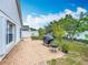 A spacious backyard with a brick patio and grill; perfect for outdoor entertaining at 1034 Copenhagen Way, Winter Garden, FL 34787