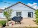 A home's backyard patio includes a grill, sliding glass door, and manicured landscaping at 1034 Copenhagen Way, Winter Garden, FL 34787