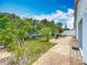 A spacious backyard featuring a brick patio, lush lawn, privacy fence and a grill at 1034 Copenhagen Way, Winter Garden, FL 34787