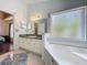 Bathroom featuring vanity with countertop space, a soaking tub and separate shower at 1034 Copenhagen Way, Winter Garden, FL 34787
