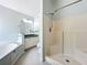 Bright bathroom with a relaxing soaking tub and white tiled walk-in shower at 1034 Copenhagen Way, Winter Garden, FL 34787