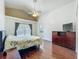 Bright bedroom with vaulted ceiling, wood floors, and a window with a view of the backyard at 1034 Copenhagen Way, Winter Garden, FL 34787