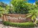 Brick Sterling Pointe community sign with manicured landscaping, bushes, and palm trees in front of community at 1034 Copenhagen Way, Winter Garden, FL 34787