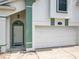 The front entrance showcases a white door, green trim, mosaic tiles, and a two-car garage door at 1034 Copenhagen Way, Winter Garden, FL 34787