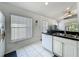 Bright kitchen features white cabinets, black countertops and tile flooring at 1034 Copenhagen Way, Winter Garden, FL 34787