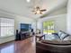 Open living room offers hardwood flooring, vaulted ceilings, ceiling fan and slider to back yard at 1034 Copenhagen Way, Winter Garden, FL 34787