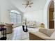 Bright living room featuring a fan, tile flooring, front windows, and comfortable seating at 1034 Copenhagen Way, Winter Garden, FL 34787