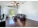 Open living room offers hardwood flooring, vaulted ceilings, ceiling fan and slider to back yard at 1034 Copenhagen Way, Winter Garden, FL 34787